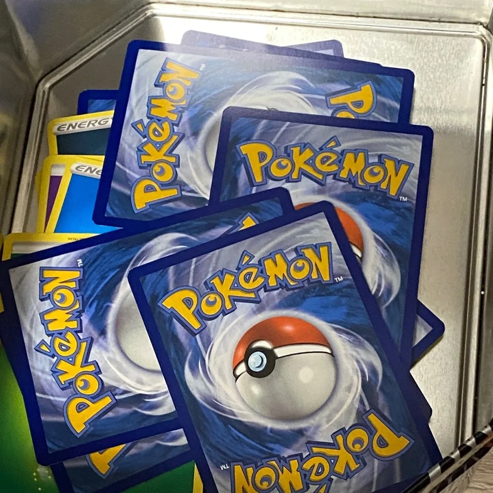 Pokemon Pikachu Yellow and Black Card Tin filled with cards and Pokémon pin